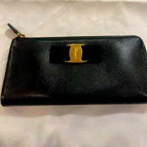 Salvatore Ferragamo leather zip around wallet with 8 credit card slots.